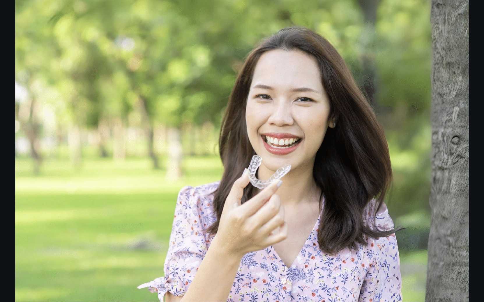Beautiful asian woman holding invisalign Invisalign