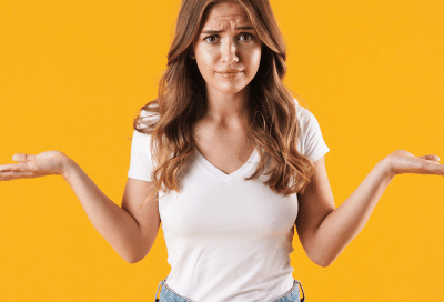 Braces vs aligners: which treatment fits your lifestyle best? 6 Young woman holding both hands out in deciding gesture over braces vs. Aligners