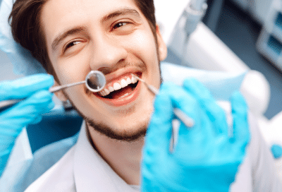 Adult orthodontics: transform your smile at any age 10 A man in a dentist chair, smiling, representing adult orthodontics