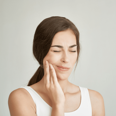 How orthodontic bite correction can improve your bite and reduce jaw strain 3 Woman holding her jaw in pain, representing orthodontic bite correction