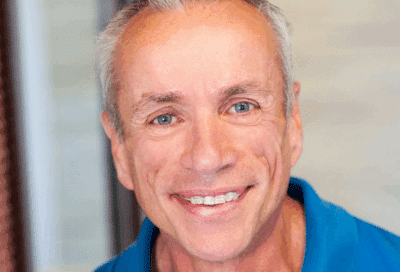 Benefits of correcting bite problems: how orthodontics fixes overbites, underbites and crossbites 5 Smiling adult male patient in a blue shirt after orthodontic treatment at eberle orthodontics