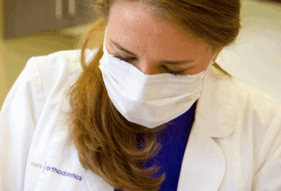 Celebrate national orthodontic health month: orthodontic treatment in denver co 4 Dr. Nicole eberle working on a patient's teeth, representing orthodontic treatment in denver co